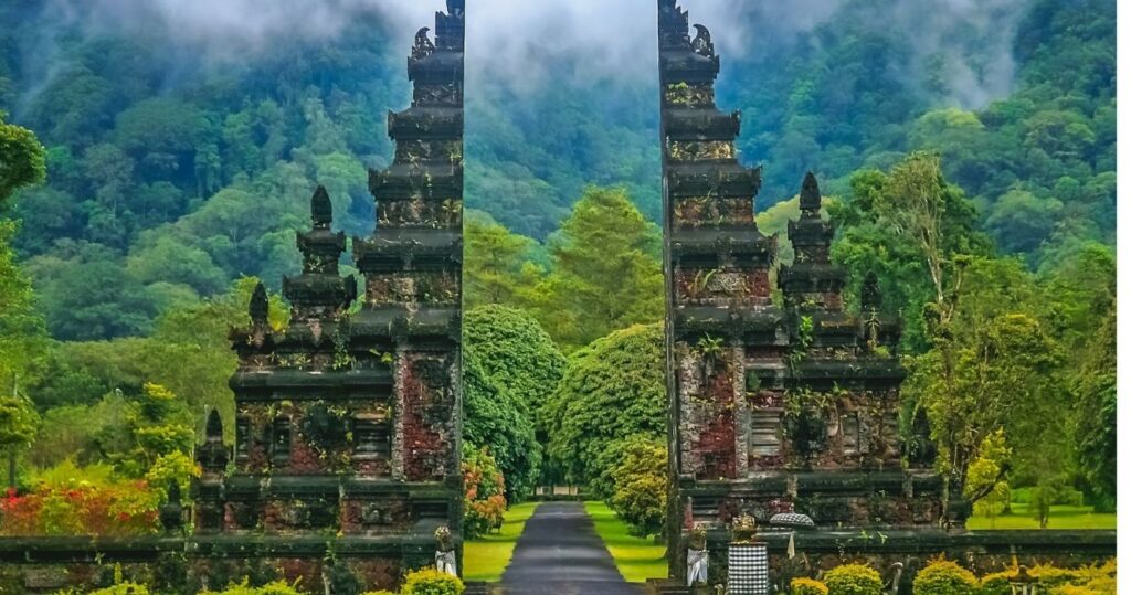 an entrance to a temple on a misty day in bali