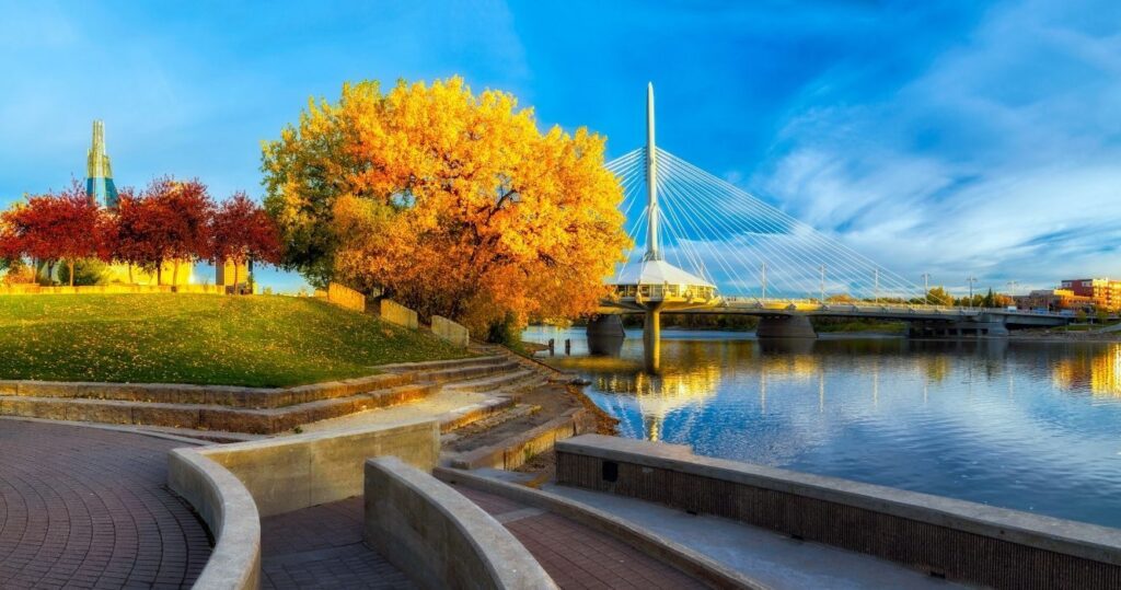 a city in manitoba on the water at sunset