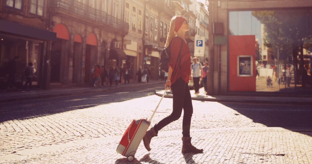 a traveler walking through rome with luggage