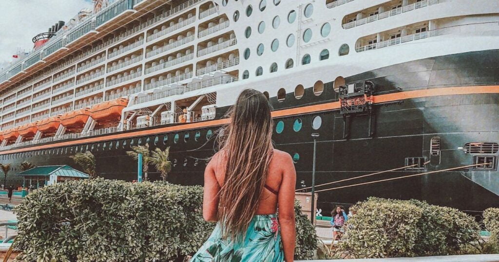 Woman looking at Disney cruise ship at port