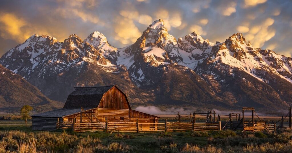 the sunset over mormon row historic district in grand teton