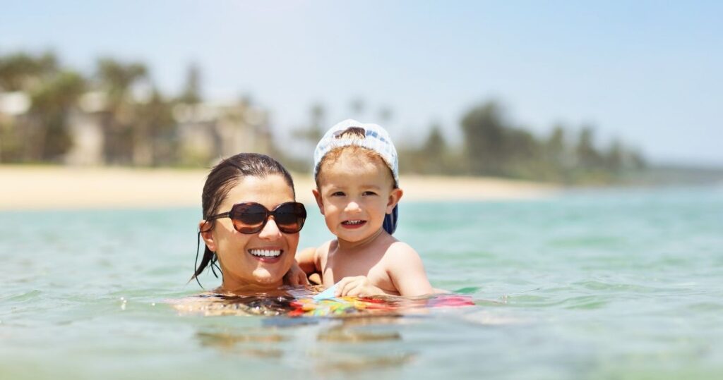 a mother and her child on the beach in puerto rico