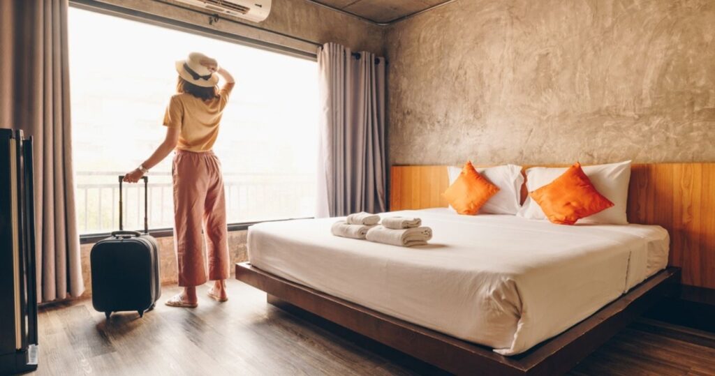 a hotel guest looking out a hotel room window