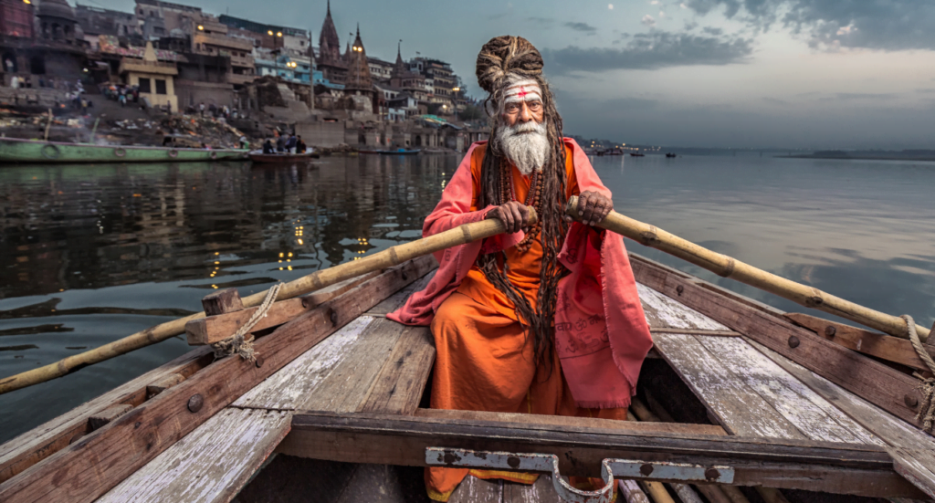 Picture of an old Indian man rowing on the Ganges