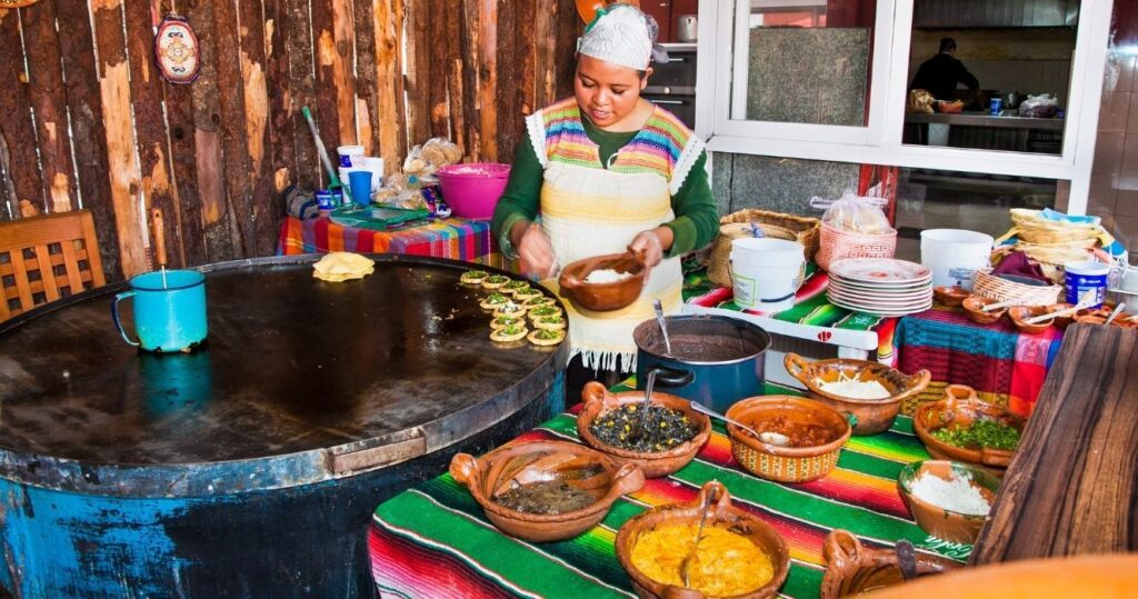 a vendor in mexico preparing traditional street food