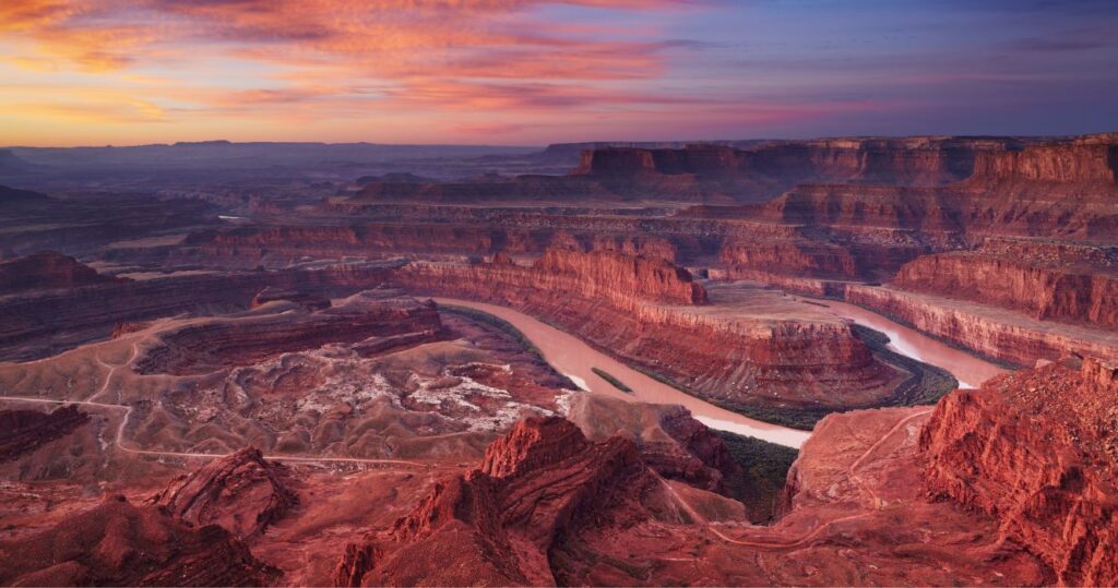 the sunset over canyonlands from dead horse point overlook